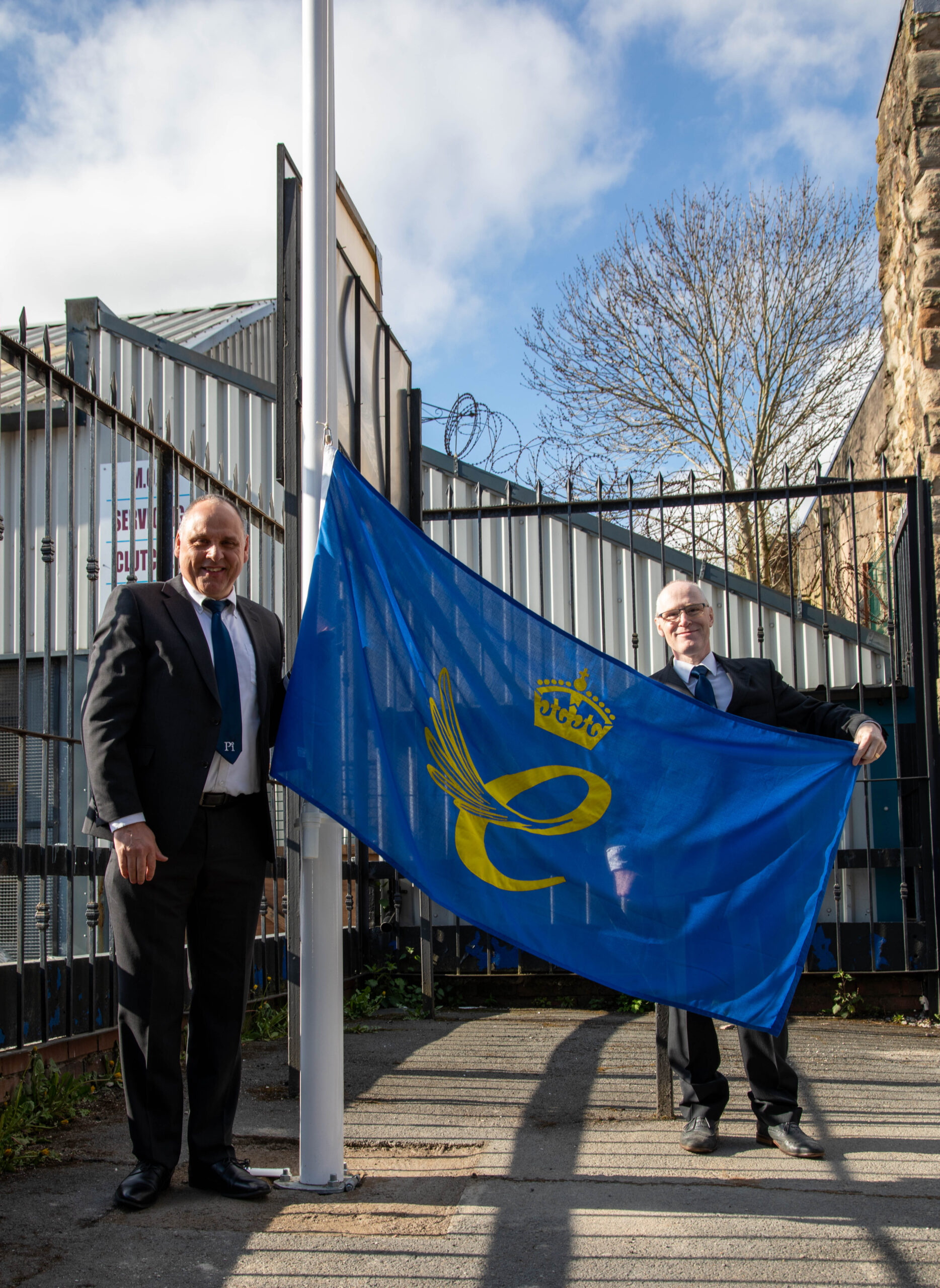 Mike Riding and Jonathan Cook from Pi raising the Queen's Award for Enterprise flag